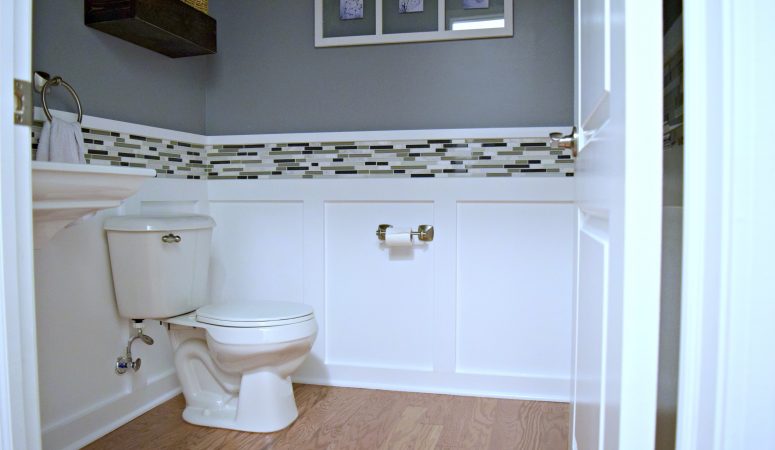 Here is an easy DIY budget powder room makeover! We used easy projects to go from builder grade to modern. Click to see how we did it!