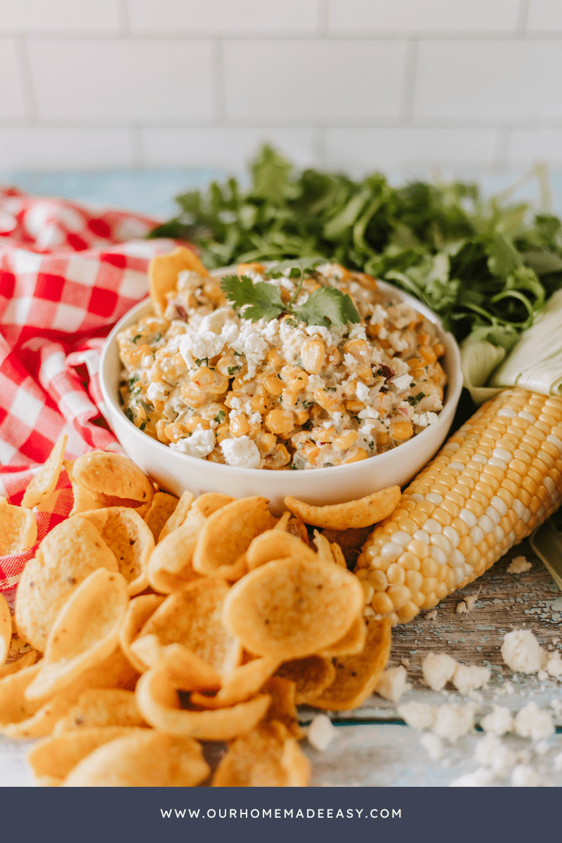 mexican street corn dip with corn chips on table top