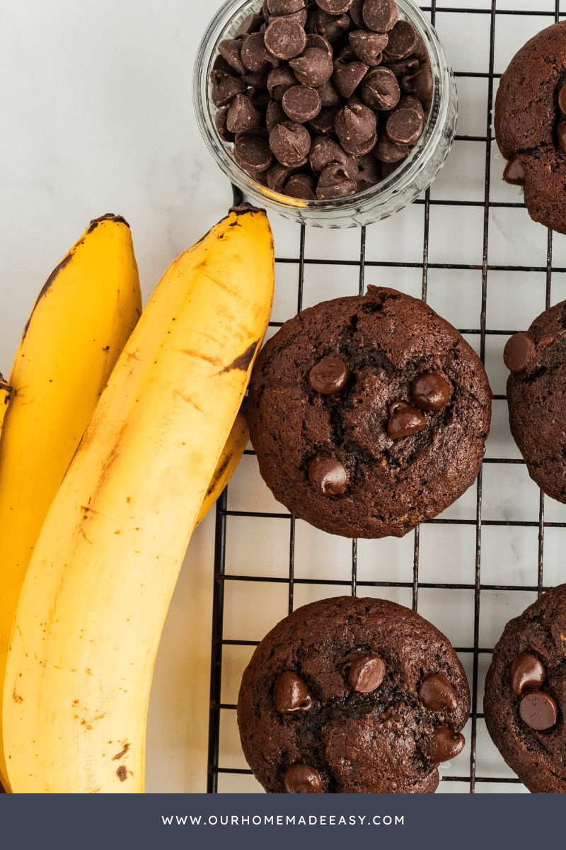 Close up finished chocolate banana muffins on wire cooling rack