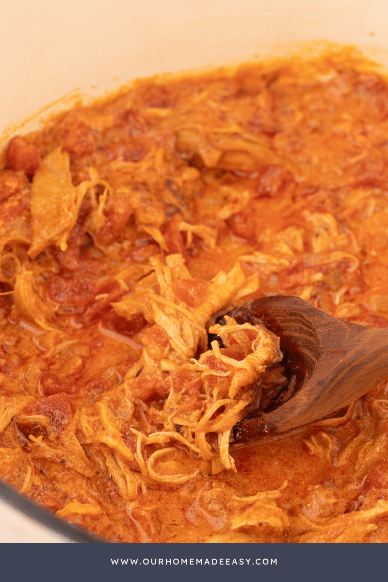 Chicken paprikash in pot with wooden spoon