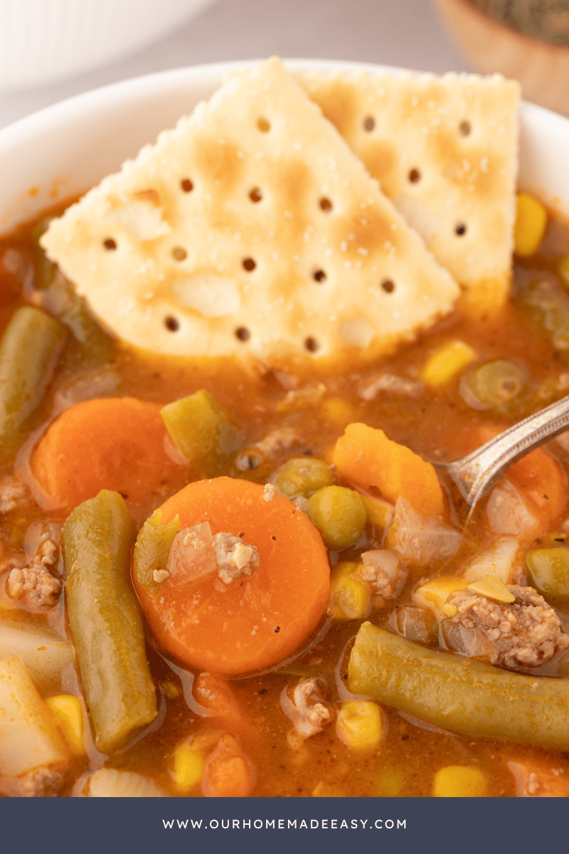 Crackers and Ladle close up of Ground Beef Vegetable Soup