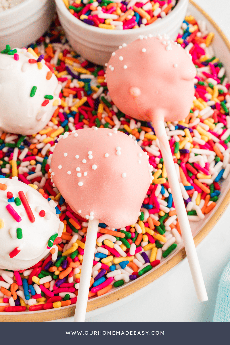 Vanilla Cake Pops lying over sprinkles