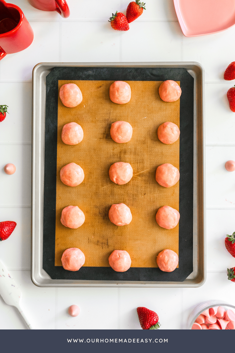 Strawberry Cake Mix cookies in process on baking sheet