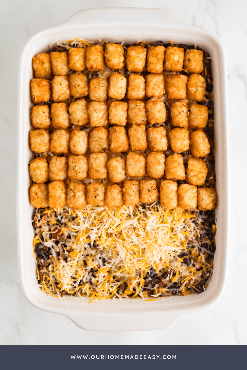 Taco Tater Tot Casserole being assembled by layer