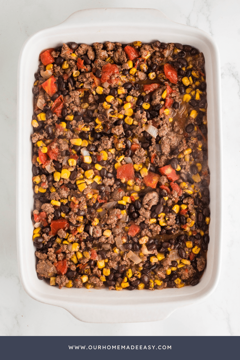 Taco Tater Tot Casserole being assembled by layer