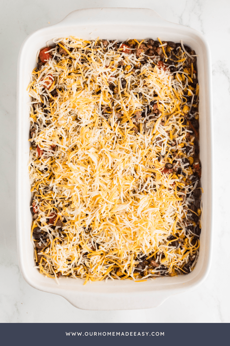 Taco Tater Tot Casserole being assembled by layer