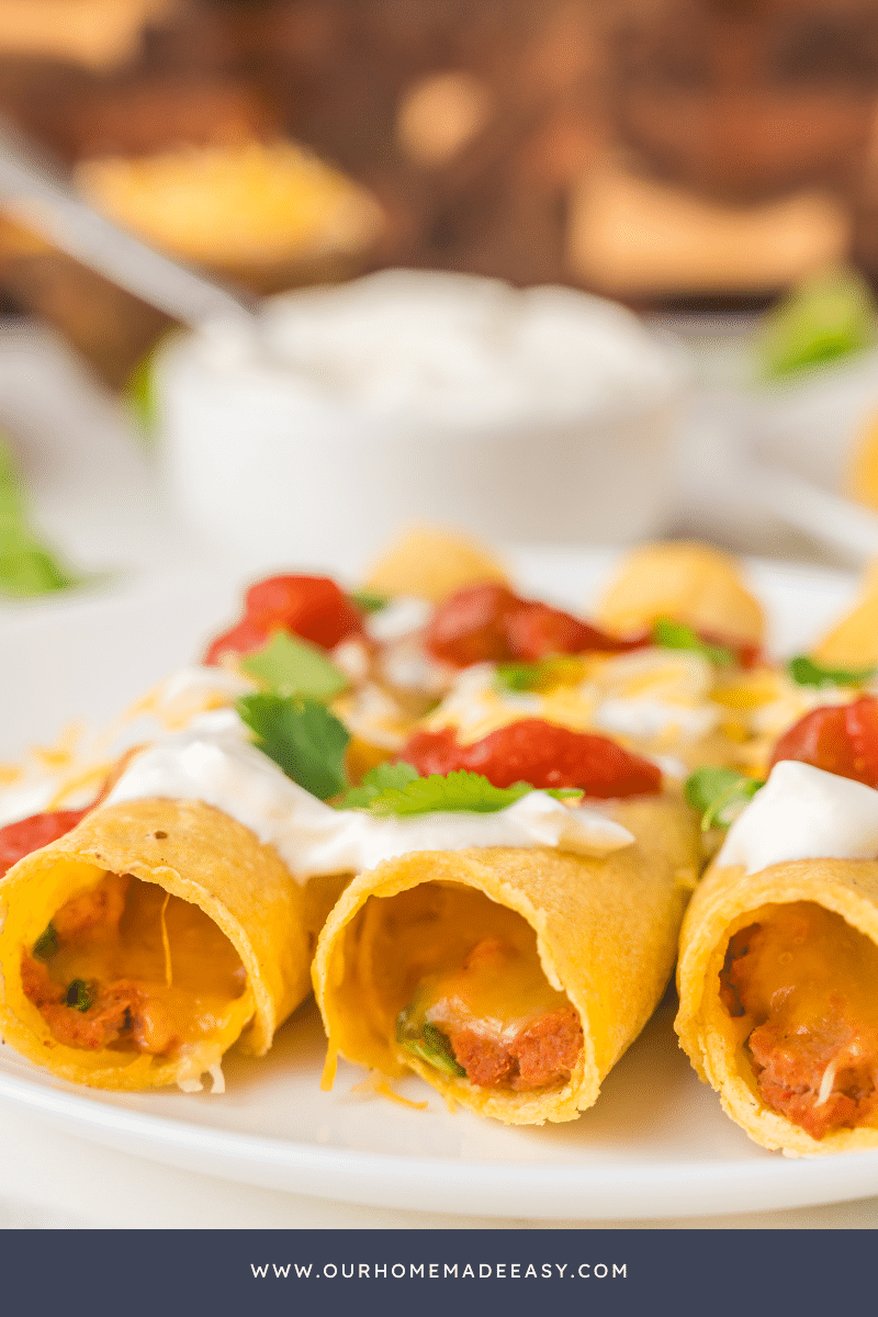 sour cream and cilantro on taquitos