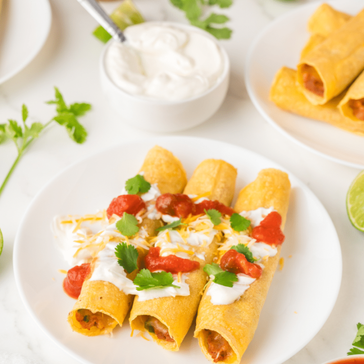 Finished taquitos on white plate