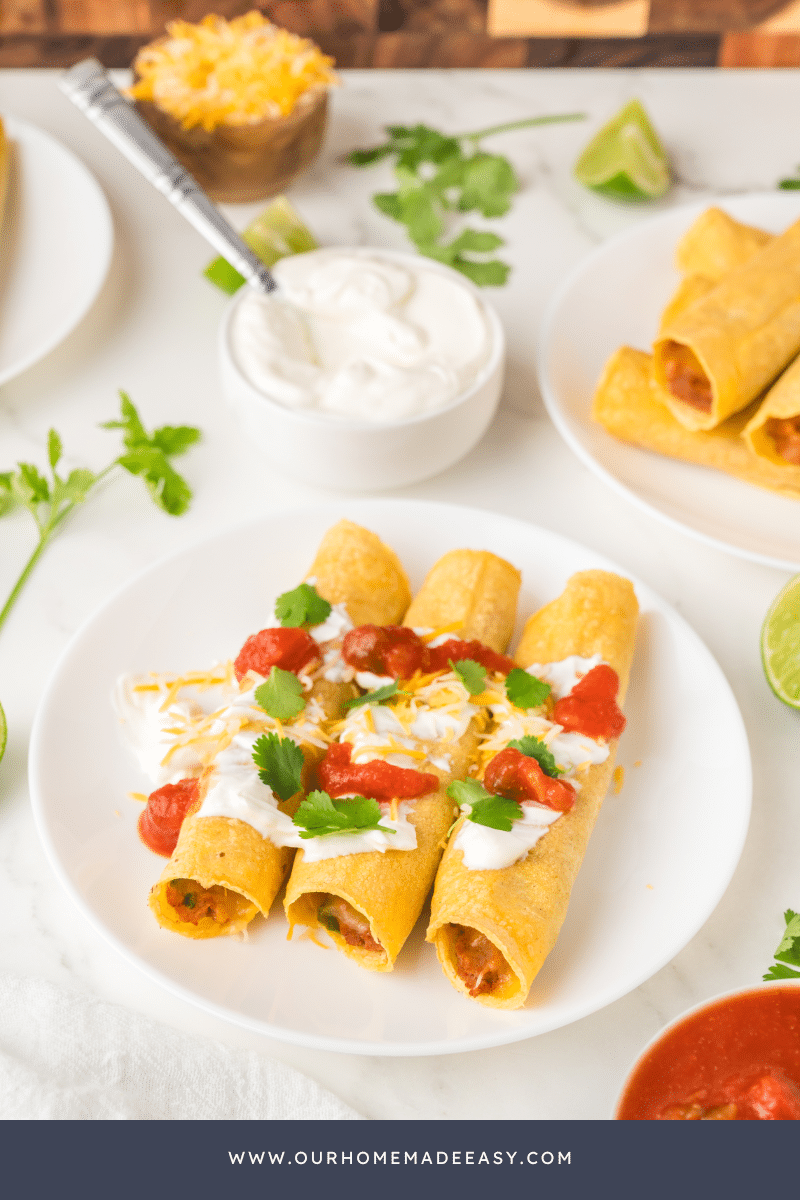 Finished taquitos on white plate