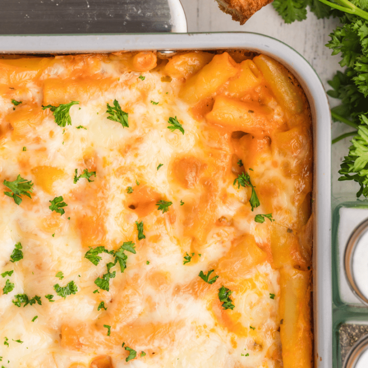 close up of untouched baked ziti with choose and parsley