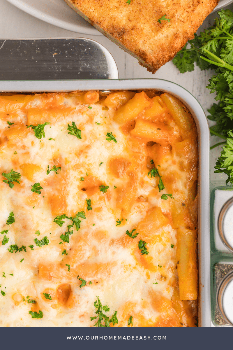 close up of untouched baked ziti with choose and parsley