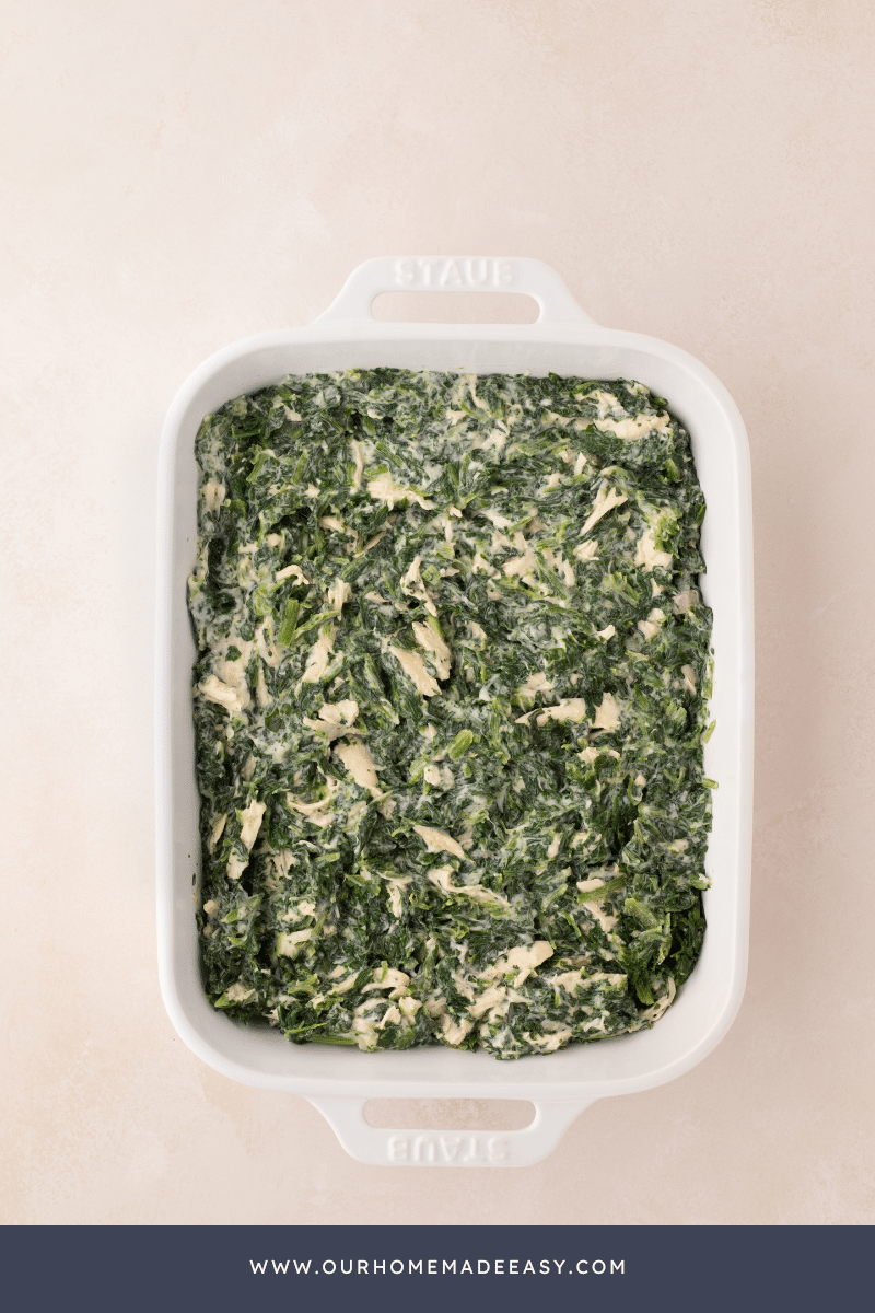 Cheesy Chicken Spinach Casserole in baking dish on table