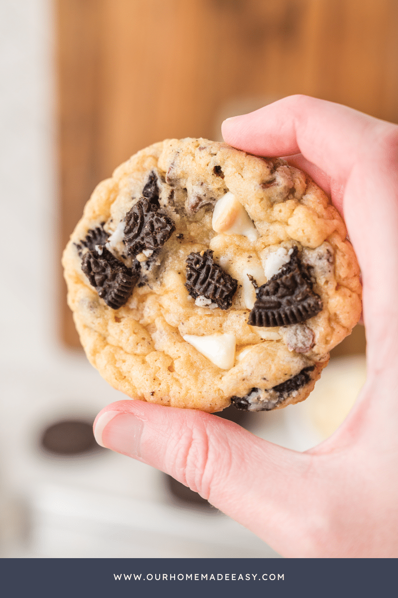 Oreo white chocolate cookies being held in a hand