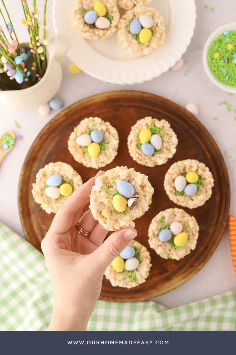 Easter Rice Krispie Treats on wooden plate being held