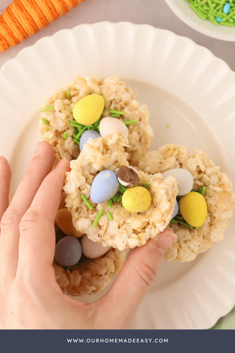 White plate with stacked birds nest rice krispies being held