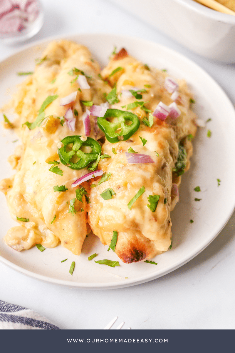 green chile chicken enchiladas on white plate