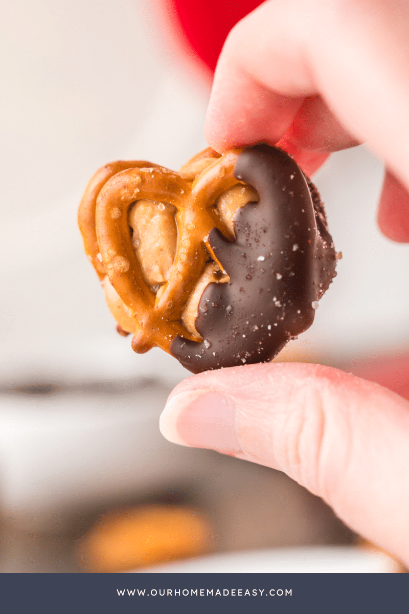 holding chocolate pretzel